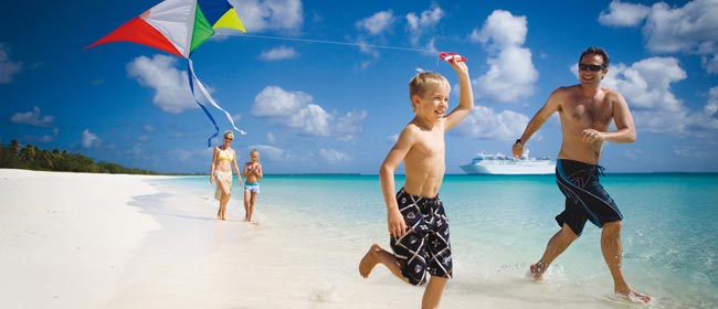 Children on the beach playing with a Kite